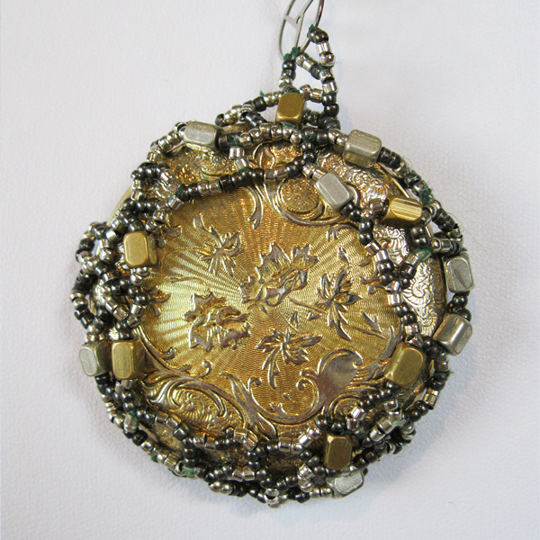 Beaded Steampunk pendant made of a web of woven metal beads framing a pocketwatch case with floral carvings