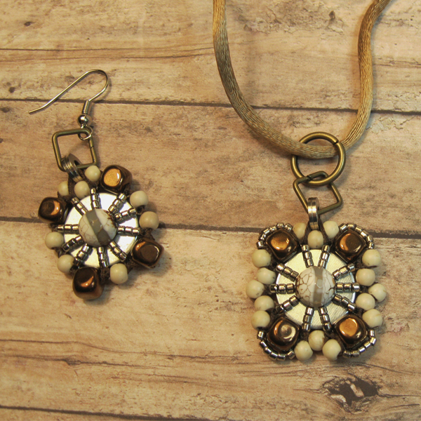 Matching set of earrings and a necklace, each with a nickel washer at the center of a design with metal, wood and glass beads with an agate bead at the center