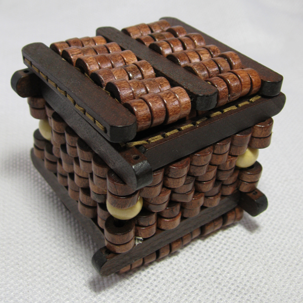 Beaded box with walls, lid and base made of wooden beads