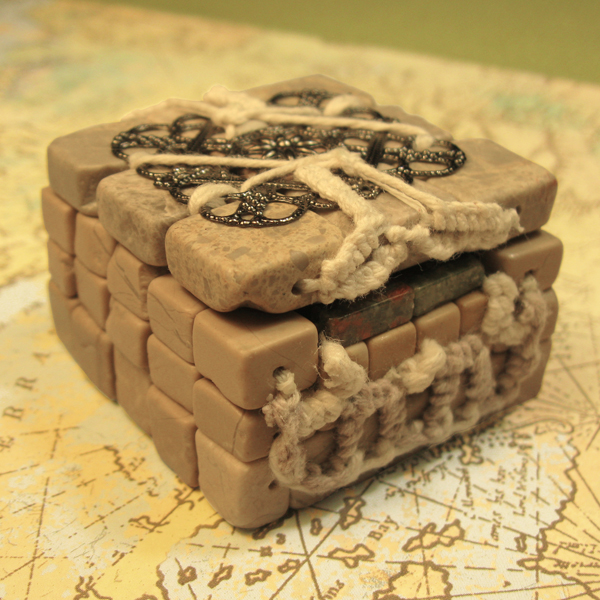 Square beaded box with taupe marble walls and base, attached feldspar lid and elements made of unakite, metal and cotton cord