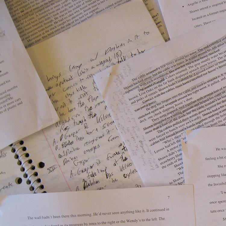 flashcards spread on table and laptop; printed and handwritten pages of stories
